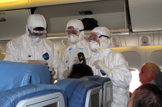 Healthcare workers checking temperatures in flight