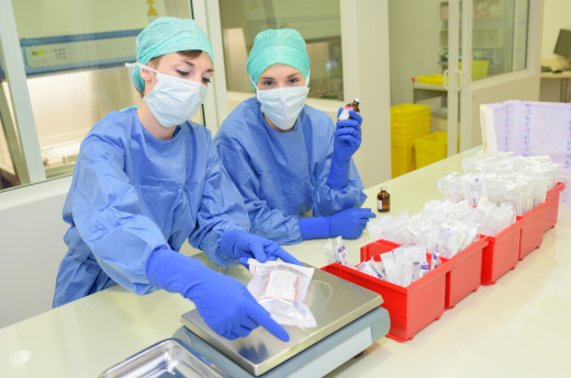 two people wearing personal protective equipment in a lab 