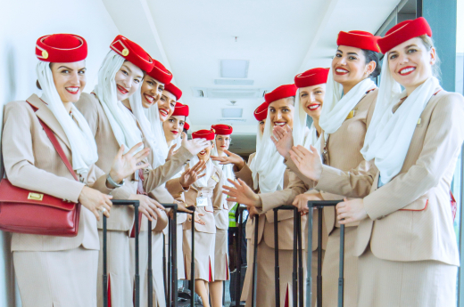 Women in brown blazer and brown skirts set - air hostesses 