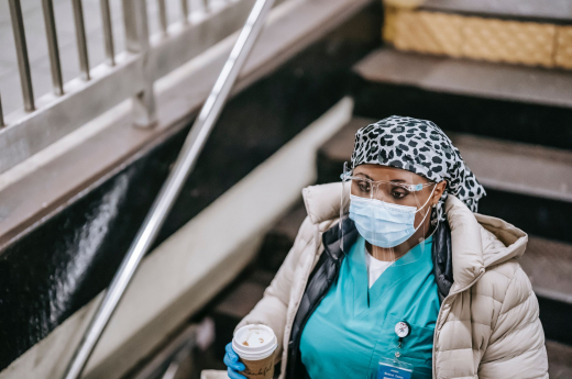 health care worker holding a cup of coffee