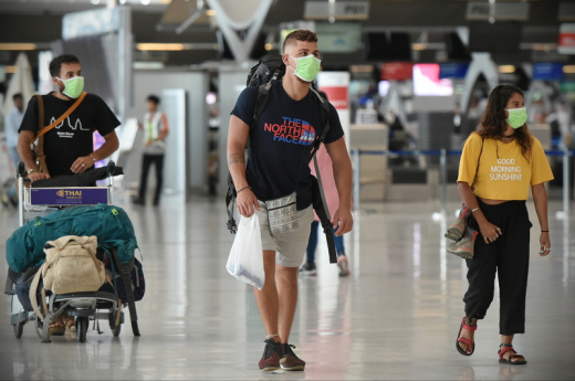 Air Travelers Wear Masks As A Precaution Against Covid-19 