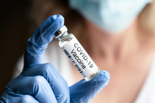 Female Doctor Holds Bottle With Covid-19 Coronavirus Vaccine In Laboratory