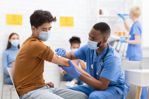 Asian Male Patient Getting Vaccinated Against Coronavirus In Hospital